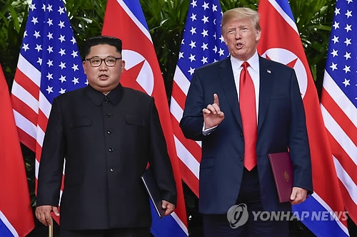 This AP photo shows U.S. President Donald Trump (R) and North Korean leader Kim Jong-un meeting in Singapore on June 12, 2018. (Yonhap)