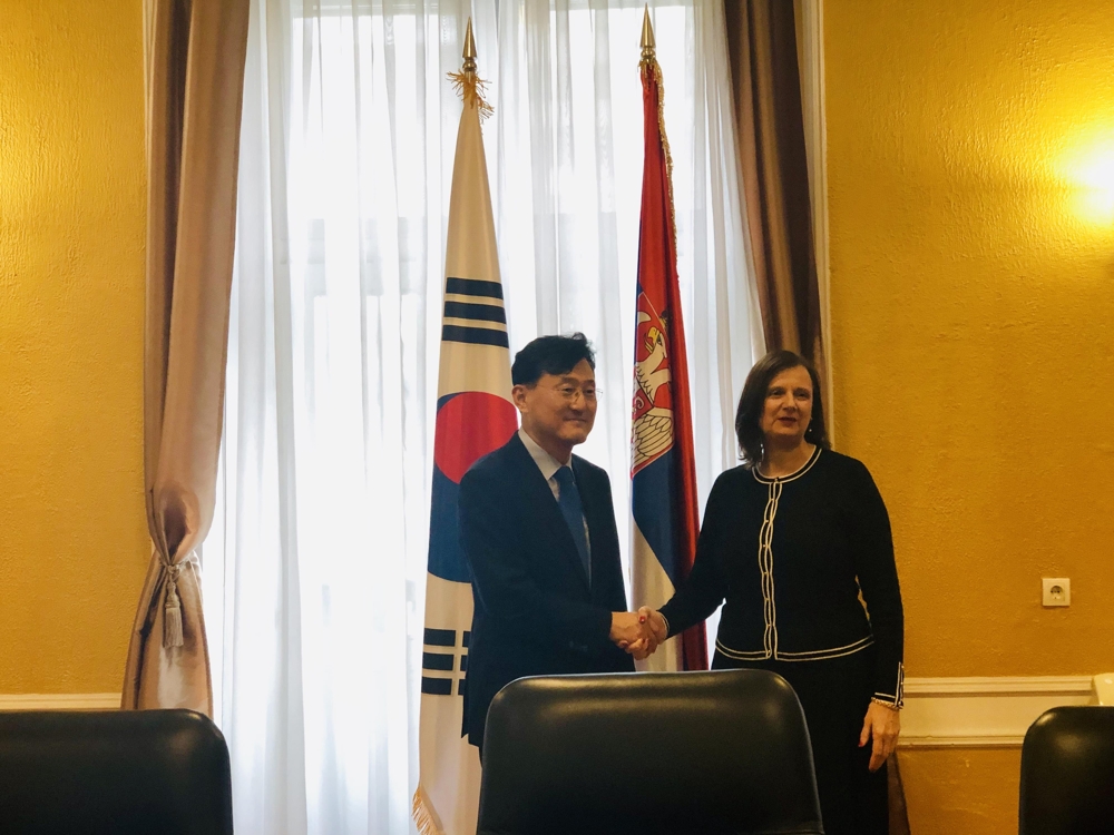 In this photo provided by Seoul's foreign ministry, Deputy Foreign Minister for Political Affairs Yoon Soon-gu shakes hands with his Serbian counterpart, Tatjana Conic, assistant minister for bilateral affairs, ahead of their meeting in Belgrade, on Oct. 3, 2019. (Yonhap)