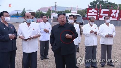 This image captured from North Korea's state TV on July 20, 2020, shows leader Kim Jong-un visiting a construction site while holding a cigarette in his hand. (For Use Only in the Republic of Korea. No Redistribution) (Yonhap)