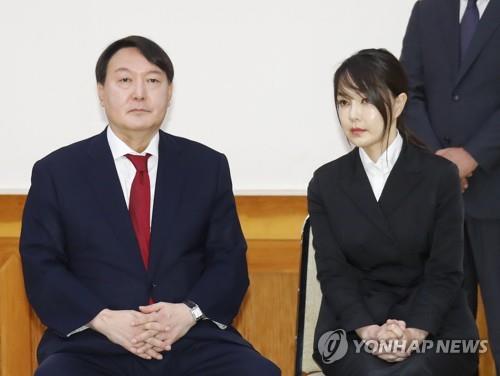 This file photo shows Prosecutor General Yoon Seok-youl on the left and his wife during an appointment ceremony at the presidential office Cheong Wa Dae in Seoul on July 25, 2019. (Yonhap)