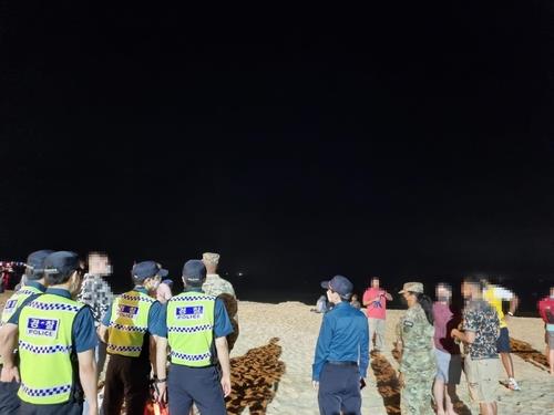 This photo, provided by the Busan Metropolitan Police Agency, shows local police cracking down on U.S. Forces Korea members and other foreigners who have violated social distancing rules on Haeundae Beach in Busan, about 450 kilometers southeast of Seoul, in May 2021. (PHOTO NOT FOR SALE) (Yonhap)