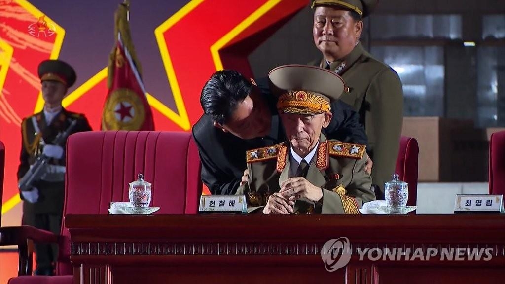 This file photo, captured from the North's official Korean Central Television on July 28, 2021, shows leader Kim Jong-un talking in close proximity to Hyon Chol-hae, marshal of the Korean People's Army, during a national conference of war veterans to celebrate the 68th anniversary of the end of the 1950-53 Korean War. (For Use Only in the Republic of Korea. No Redistribution) (Yonhap)