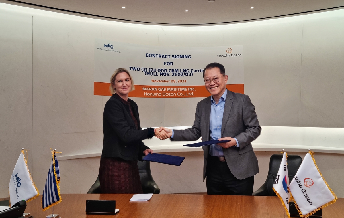 Hanwha Ocean Co. CEO Kim Hee-cheul (R) and Maran Gas Maritime Inc. CEO Maria Angelicoussis shake hands after signing a deal for two liquefied natural gas carriers, in this photo taken Nov. 8, 2024. (PHOTO NOT FOR SALE) (Yonhap)