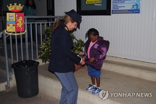 코트디부아르 출신의 4살짜리 난민 우오모와 그를 돌보는 볼페 이탈리아 경감