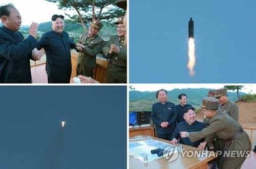 화성-12형 시험발사 성공에 기뻐하는 김정은과 참모들