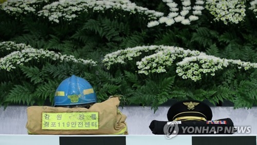 (강릉=연합뉴스) 양지웅 기자 = 19일 오전 강원 강릉시청에서 열린 강원도 순직 소방공무원 합동 영결식에서 이영욱 소방경의 방화복(왼쪽)과 정복이 놓여있다. 강릉소방서 경포 119안전센터 소속 이영욱(59) 소방경과 이호현(27) 소방교는 지난 17일 강릉시 강문동 석란정에서 불을 끄다 순직했다. 2017.9.19