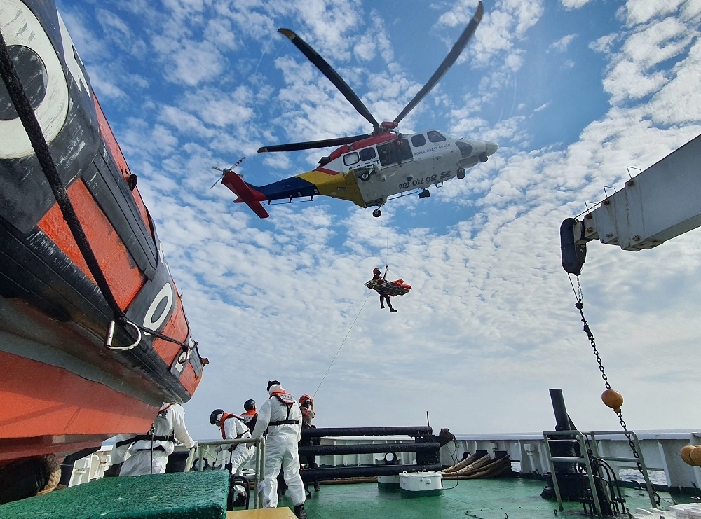 해양경찰관이 헬기로 환자를 이송하는 모습