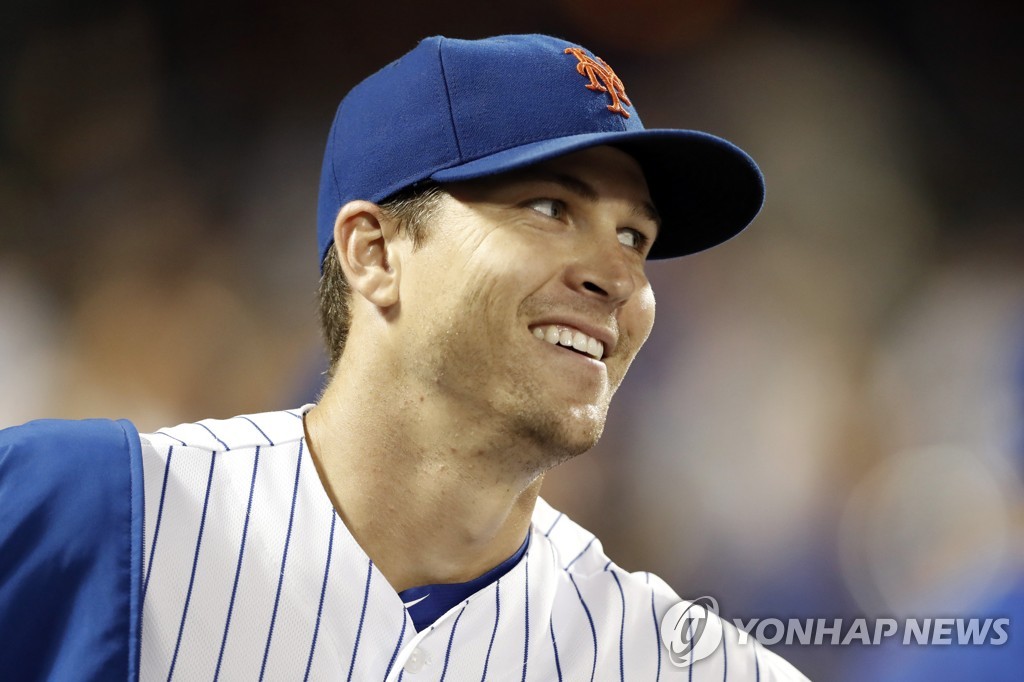 In this Associated Press photo, New York Mets' starter Jacob deGrom smiles after pitching seven innings against the Arizona Diamondbacks in their Major League Baseball regular season game at Citi Field in New York on Sept. 9, 2019. (Yonhap)