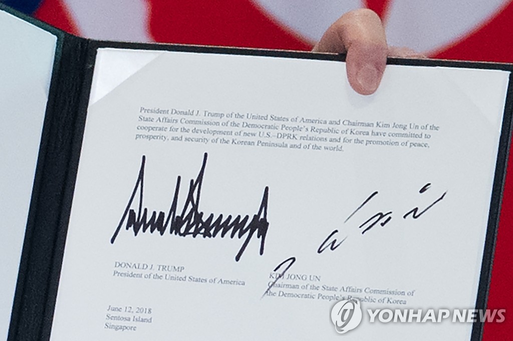북미정상회담 공동합의문 들어보이는 트럼프