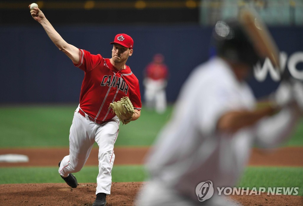 In this AFP photo, Brock Dykxhoorn of Canada throws in the bottom of the first inning of a Group C game against Australia at the Premier12 at Gocheok Sky Dome in Seoul on Nov. 8, 2019. (Yonhap)