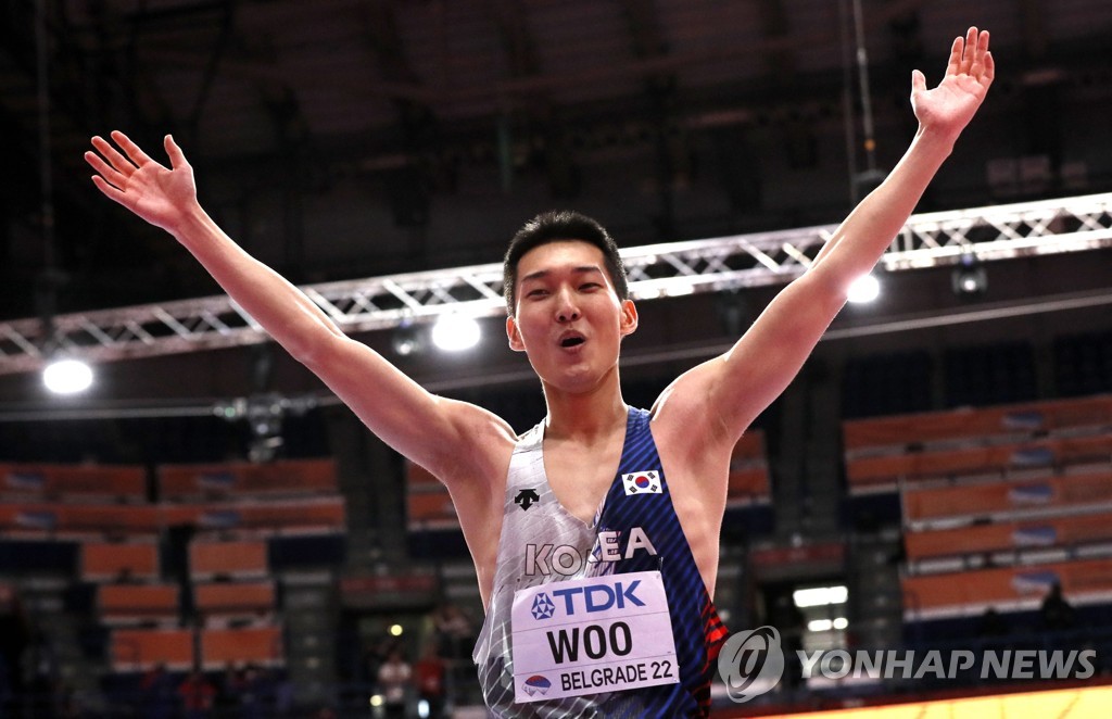 In this EPA file photo from March 20, 2022, Woo Sang-hyeok of South Korea celebrates after winning gold in the men's high jump at the World Athletics Indoor Championships at Stark Arena in Belgrade. (Yonhap)