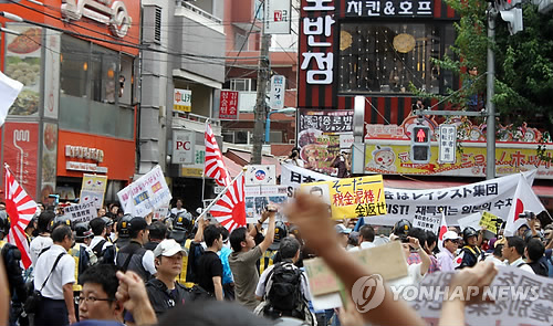 일본 도쿄 도심에서 열린 반한(反韓) 시위에서 '재일(在日) 특권을 용납하지 않는 시민모임'(이하 재특회) 소속 참가자가 피켓을 들고 행진하고 있다. <<연합뉴스DB>>