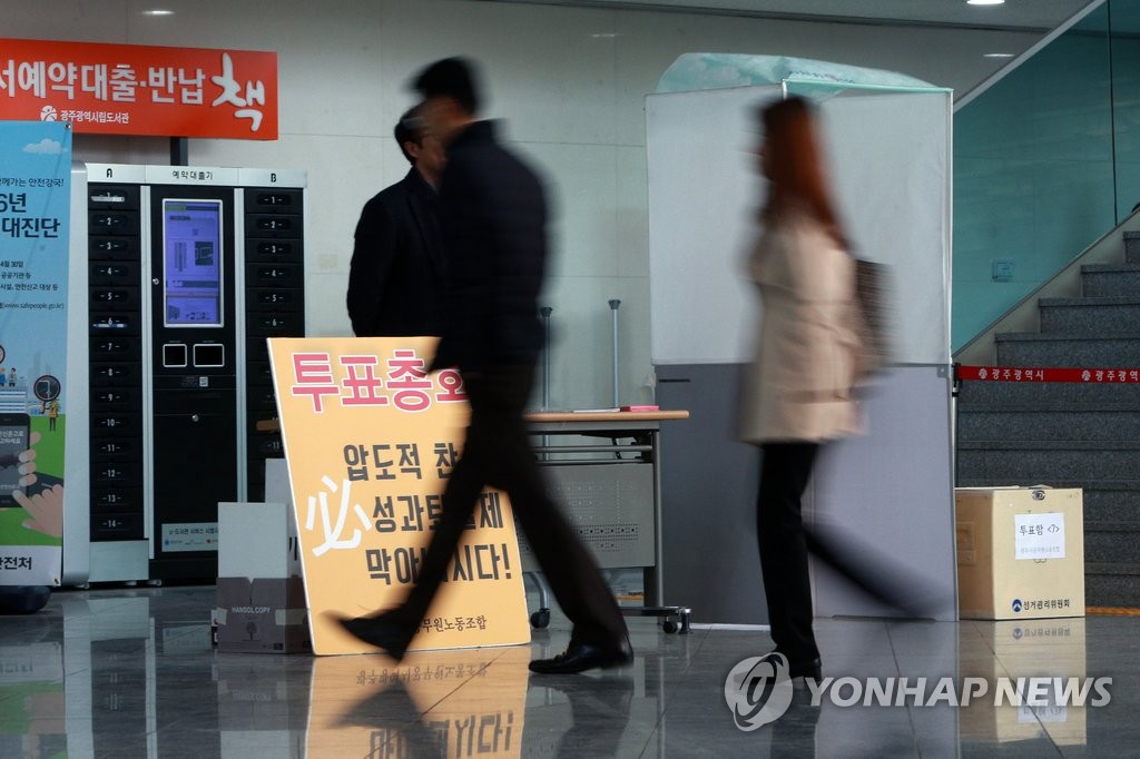 지난달 21일 광주시공무원노조는 전국공무원노동조합 가입투표를 재개했다.사진은 이날 광주시청 로비에 설치된 기표소 앞을 지니가는 공무원들의 모습
