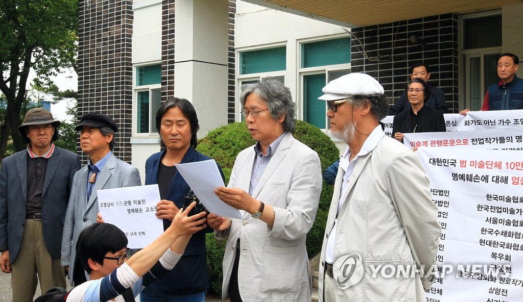 14일 조영남 씨 대작 의혹 사건과 관련해 명예훼손 혐의로 검찰에 고소한 11개 미술단체가 고소장 제출에 앞서 춘천지검 속초지청 앞에서 성명을 발표하고 있는 모습