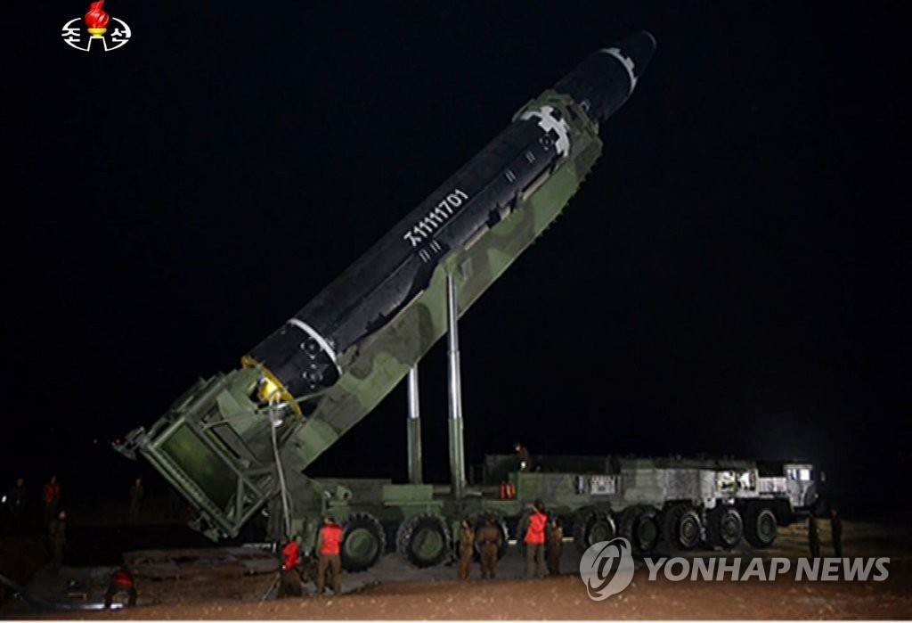 The image captured from North Korea's Korean Central Television on Nov. 30, 2017, shows a missile being placed into an upright position on a mobile launcher the previous day when the North test fired the new intercontinental ballistic missile, called the Hwasong-15. (For Use Only in the Republic of Korea. No Redistribution) (Yonhap)
