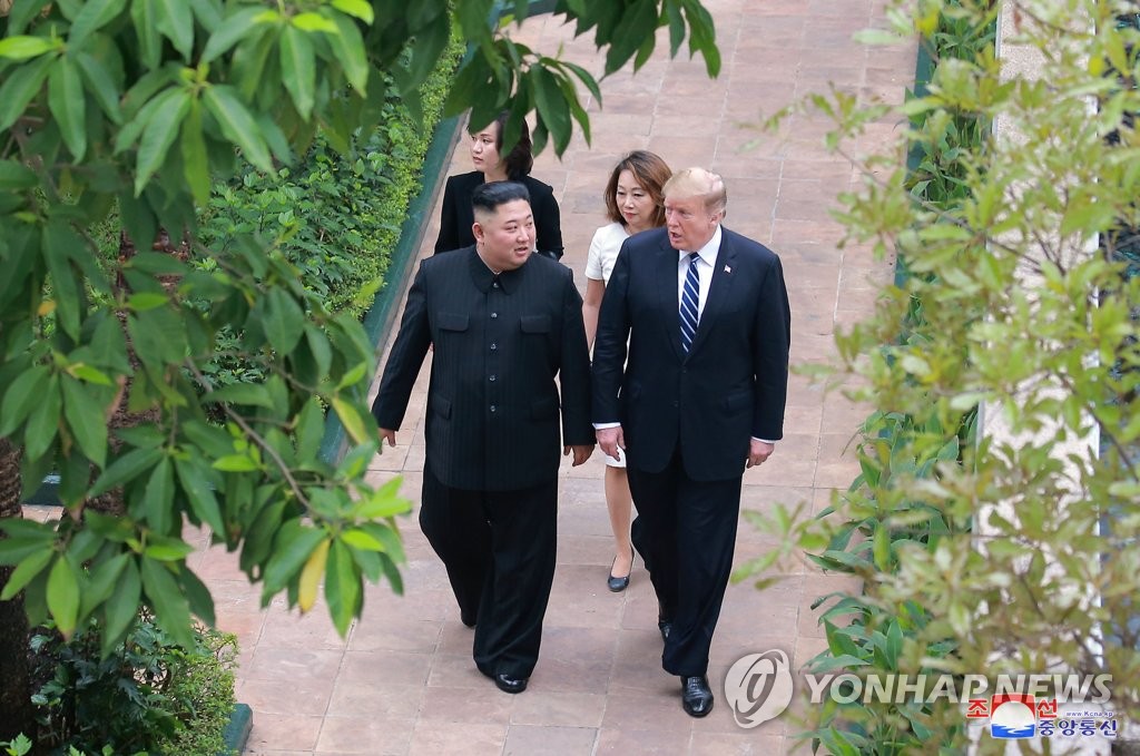 North Korean leader Kim Jong-un (L) and U.S. President Donald Trump take a stroll at the Sofitel Legend Metropole hotel in Hanoi on Feb. 28, 2019, in this photo carried by the North's official Korean Central News Agency the next day. (For Use Only in the Republic of Korea. No Redistribution) (Yonhap)