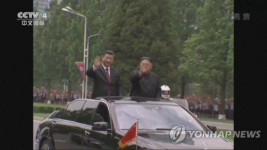 Xi riding in parade through Pyongyang Xi riding in parade through Pyongyang