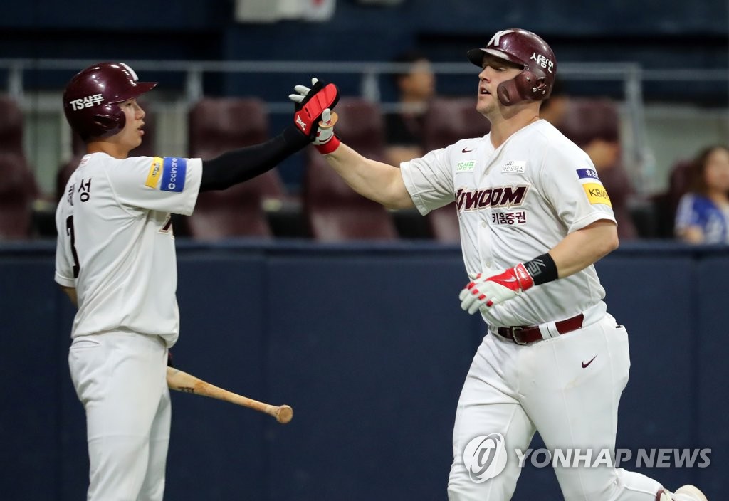 Jerry Sands of the Kiwoom Heroes (R) high-fives teammate Kim Hye-seong after hitting a two-run home run against the Samsung Lions in the bottom of the second inning of a Korea Baseball Organization regular season game at Gocheok Sky Dome in Seoul on July 17, 2019. (Yonhap)