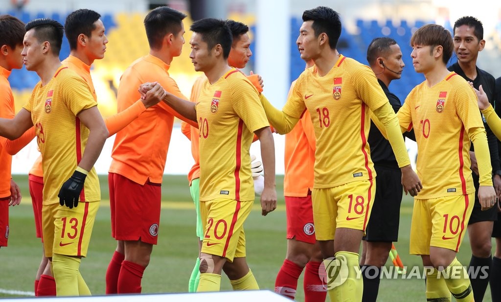 Players of the Chinese and Hong Kong men's national football teams shake hands before the start of their match at the East Asian Football Federation (EAFF) E-1 Football Championship at Busan Asiad Main Stadium in Busan, 450 kilometers southeast of Seoul, on Dec. 18, 2019. (Yonhap)