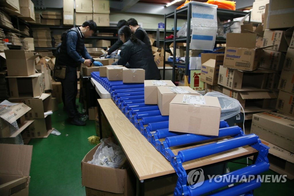 Workers busy packaging masks Workers busy packaging masks