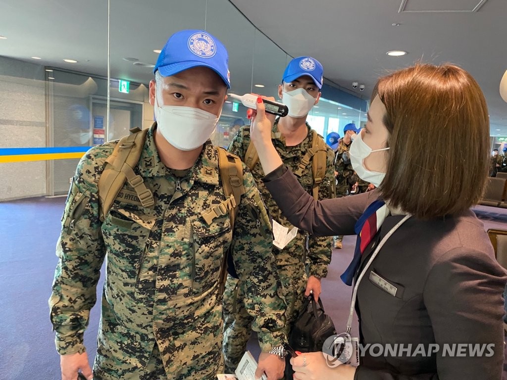 Peacekeeping troops checked for fever before boarding plane Peacekeeping troops checked for fever before boarding plane
