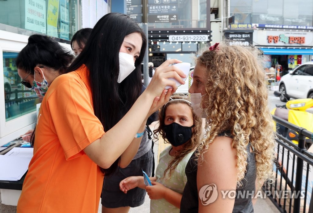 Foreigners get temperatures checked Foreigners get temperatures checked