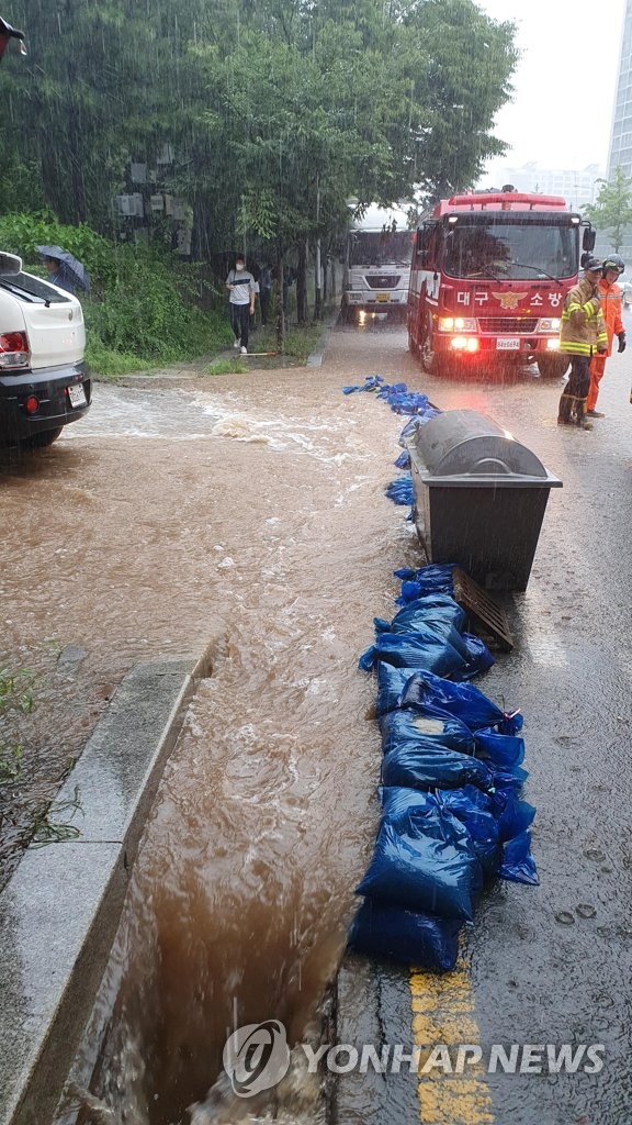 Firefighters fight water, debris Firefighters fight water, debris