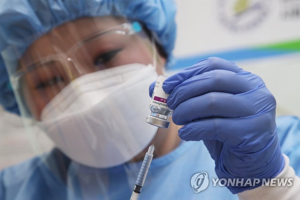 A health worker clad in a protective suit prepares for an inoculation with AstraZeneca's coronavirus vaccine at a hospital in Ansan, south of Seoul, on Feb. 26, 2021. (Yonhap)