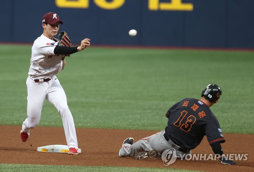 In this file photo from May 16, 2021, Kim Hye-seong of the Kiwoom Heroes (L) turns a double play against the Hanwha Eagles during the top of the first inning of a Korea Baseball Organization regular season game at Gocheok Sky Dome in Seoul. (Yonhap)