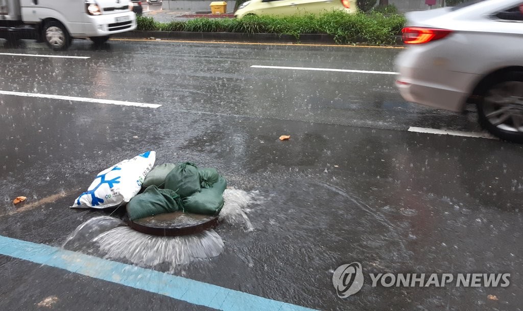 빗물에 역류하는 맨홀 뚜껑