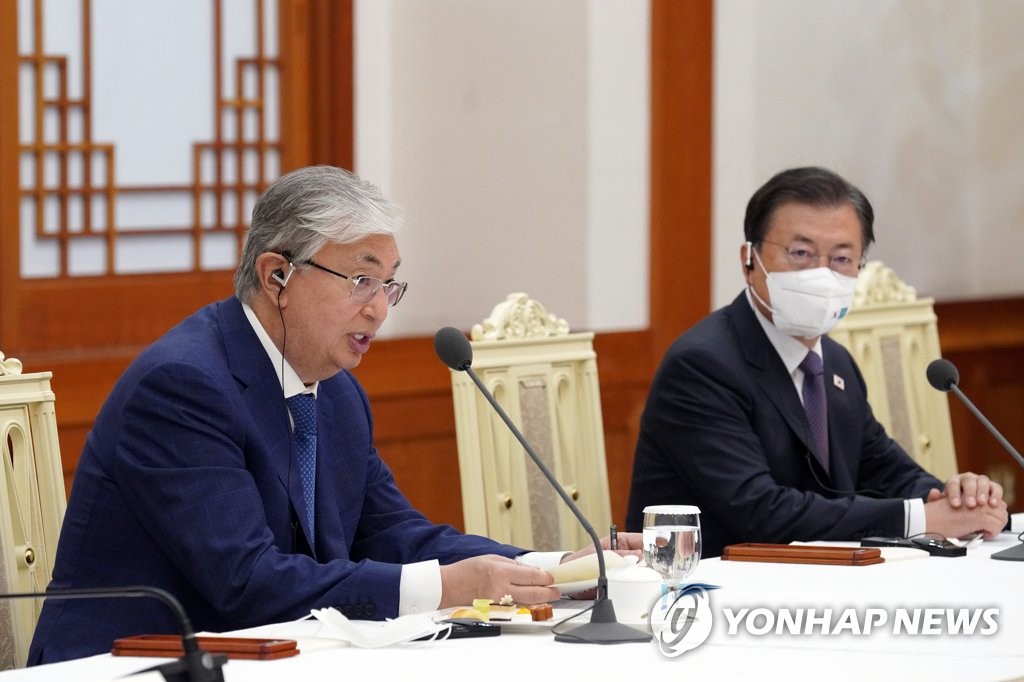 Kazakh President Kassym-Jomart Tokayev (L) speaks during a meeting with South Korean business leaders, with President Moon Jae-in seated next to him, at Cheong Wa Dae in Seoul on Aug. 17, 2021. (Yonhap)