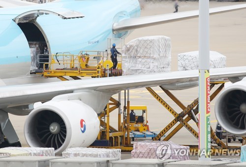 Des employés de l'aéroport international d'Incheon déchargent, le dimanche 5 septembre 2021, 1,26 million de doses du vaccin Moderna contre le nouveau coronavirus (Covid-19) qui sont arrivées à bord d'un avion cargo.