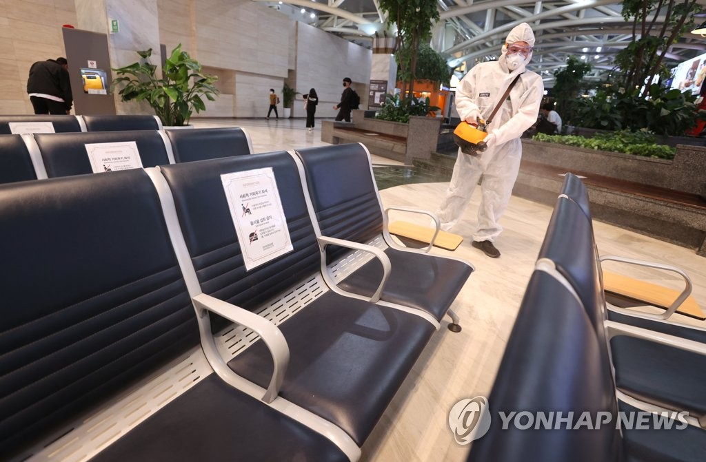 A health worker in a protective suit disinfects seats at an express bus terminal in Seoul on Sept. 17, 2021. (Yonhap)