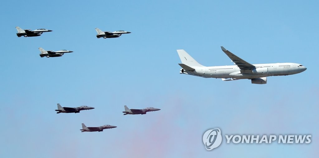 A KC-330 military tanker transport (R), flies over the Seoul Air Base located just south of Seoul on Oct 18, 2021, along with F-15K and KF-16 jets, ahead of the official opening of the Seoul International Aerospace & Defense Exhibition (ADEX). (Yonhap)