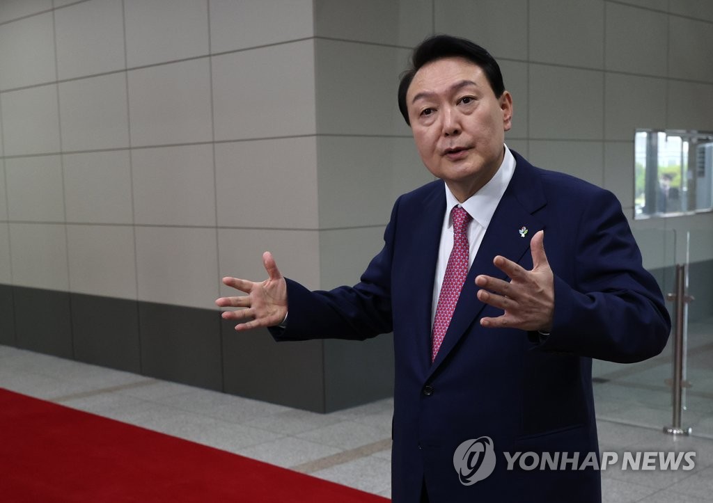 President Yoon Suk-yeol takes reporters' questions as he arrives at his office in Seoul on June 23, 2022. (Yonhap)