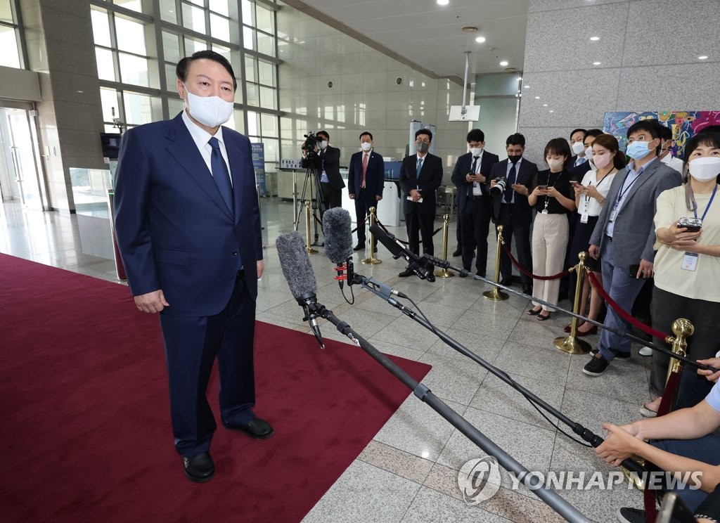President Yoon Suk-yeol speaks to reporters as he arrives at the presidential office in Seoul on Aug. 12, 2022. (Yonhap)