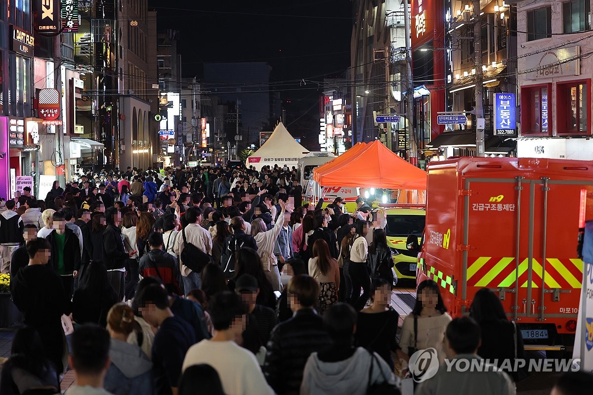 In this file photo taken on October 28, 2023, the streets near Hongik University Station are packed with people ahead of Halloween. (Yonhap)