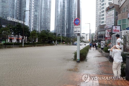 A street in South Korea's southeastern port city of Busan is completely submerged as wild waves by Typhoon Chaba stormed their way into the city's coastal areas after crossing seawalls on Oct. 5, 2016. (Yonhap) 