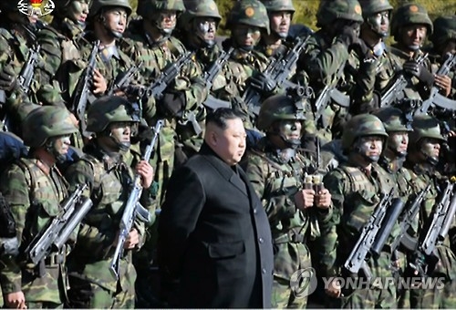 In this photo taken on Dec. 11, 2016, North Korean leader Kim Jong-un oversees a drill containing a simulation of striking the presidential house Cheong Wa Dae and other core facilities in South Korea, along with special operations troops in North Korea. (For Use Only in the Republic of Korea. No Redistribution) (Yonhap)