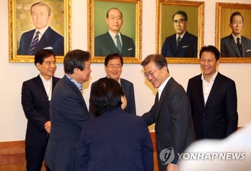 President Moon Jae-in (2nd from R) shakes hands with Culture Minister Do Jong-hwan before the start of a weekly Cabinet meeting at his office, Cheong Wa Dae, in Seoul on July 11, 2017. (Yonhap)