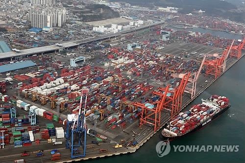 Containers carrying export goods are stacked on piers in Busan, South Korea's largest port city. (Yonhap)