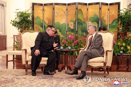 North Korean leader Kim Jong-un (L) holds talks with Singapore's Prime Minister Lee Hsien Loong in Singapore on June 10, 2018, in this photo provided by Singapore's communications and information ministry. Kim arrived in the island country earlier in the day to hold a historic summit with U.S. President Donald Trump on June 12. (Yonhap) 
