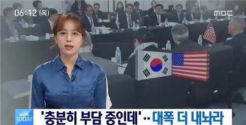 In this photo captured from a footage of MBC's morning news program, Im Hyun-joo delivers the news with her glasses on. (Yonhap) 