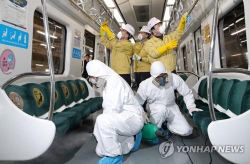 Subway workers in Gwangju, 330 kilometers south of Seoul, disinfect a passenger car on Feb. 4, 2020, amid concerns the novel coronavirus may have spread in the city. (Yonhap)