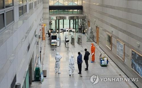 Soldiers and officials carry out disinfection work on the first basement level of the defense ministry's main building in Seoul on March 25, 2020. (PHOTO NOT FOR SALE) (Yonhap) 