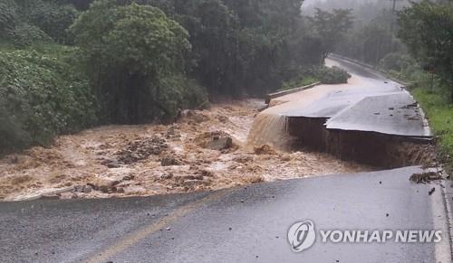 This photo, provided by the National Fire Agency, shows a collapsed road in Chungju, North Chungcheong Province, which left one firefighter missing, on Aug. 2, 2020. (PHOTO NOT FOR SALE) (Yonhap)