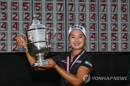 In this Getty Images file photo from June 2, 2019, Lee Jeong-eun of South Korea holds the championship trophy after winning the U.S. Women's Open at the Country Club of Charleston in Charleston, South Carolina. (Yonhap)
