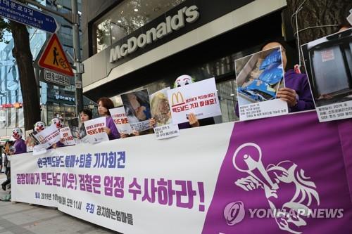 In this file photo taken on Oct. 29, 2020, civic activists hold a news conference in front of a McDonald's Korea store in downtown Seoul to call for a thorough investigation into the so-called hamburger disease case. (Yonhap)