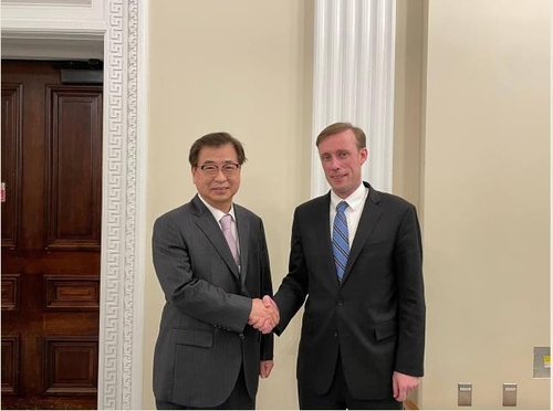 South Korea's National Security Adviser Suh Hoon (L) and his U.S. counterpart, Jake Sullivan, are seen posing for a photo during their meeting in Washington on Oct. 12, 2021 in this photo provided by the South Korean embassy in Washington. (PHOTO NOT FOR SALE) (Yonhap)