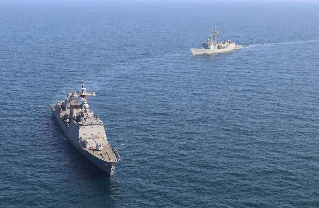This photo, released by the Ministry of National Defense on Oct. 19, 2021, shows the Navy's 4,400-ton destroyer Chungmugong Yi Sun-shin (L) and the EU's frigate Victoria. (PHOTO NOT FOR SALE) (Yonhap)